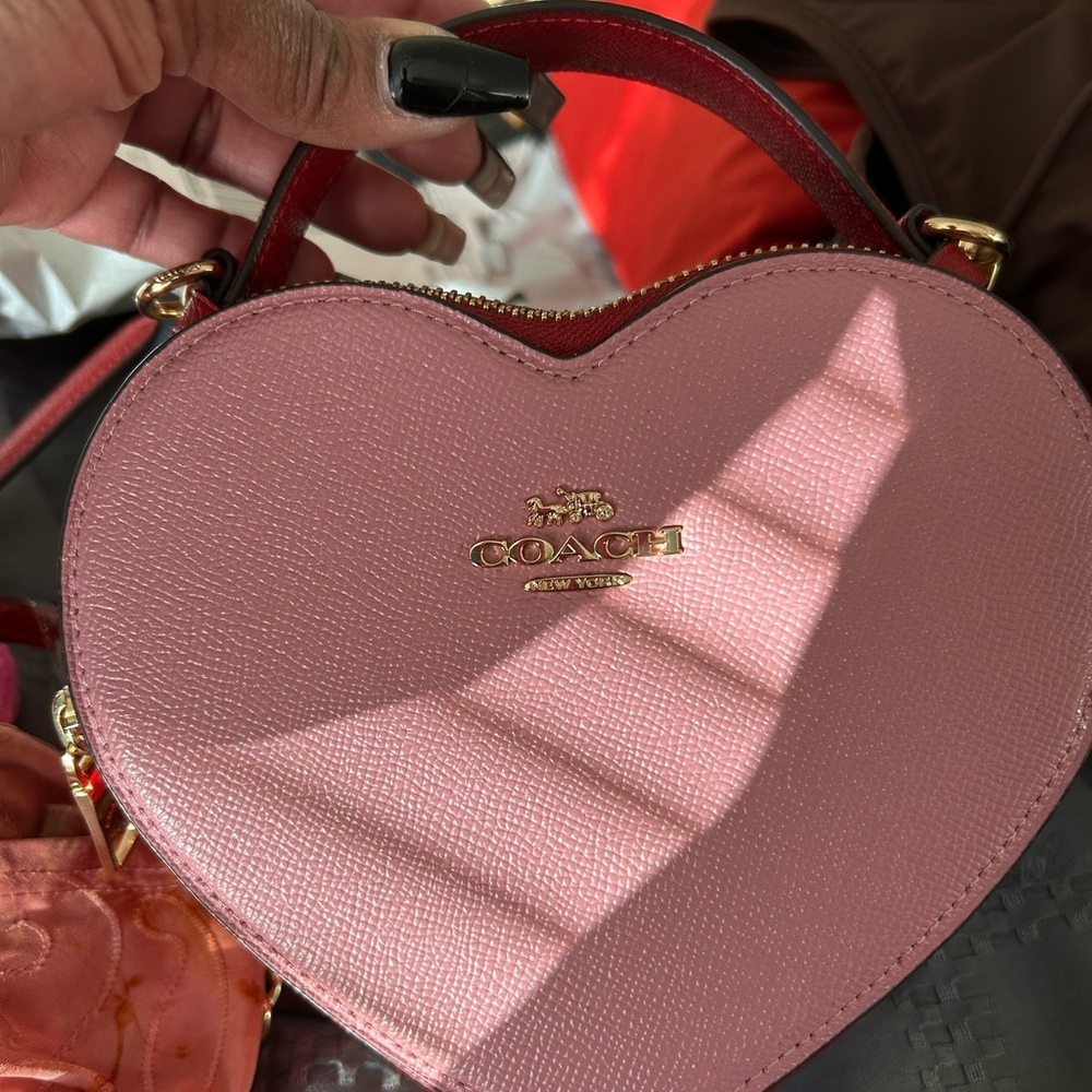 Pink heart shaped COACH crossbody no stains, tears, or odor